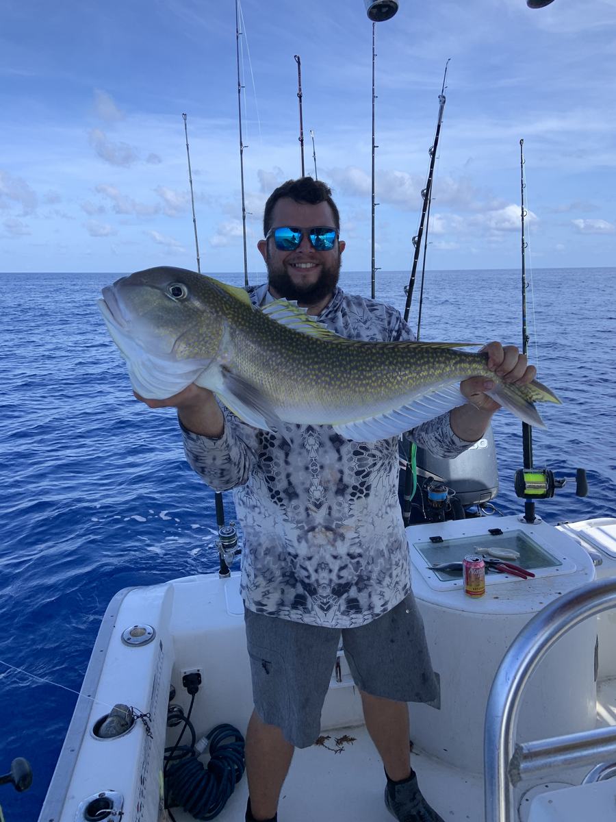 Mark Gabrielli holding a large fish on the open water